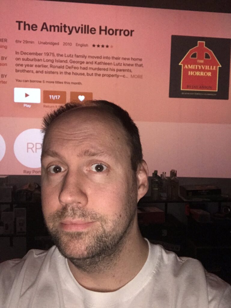 Matt with an audiobook of "The Amityville Horror"