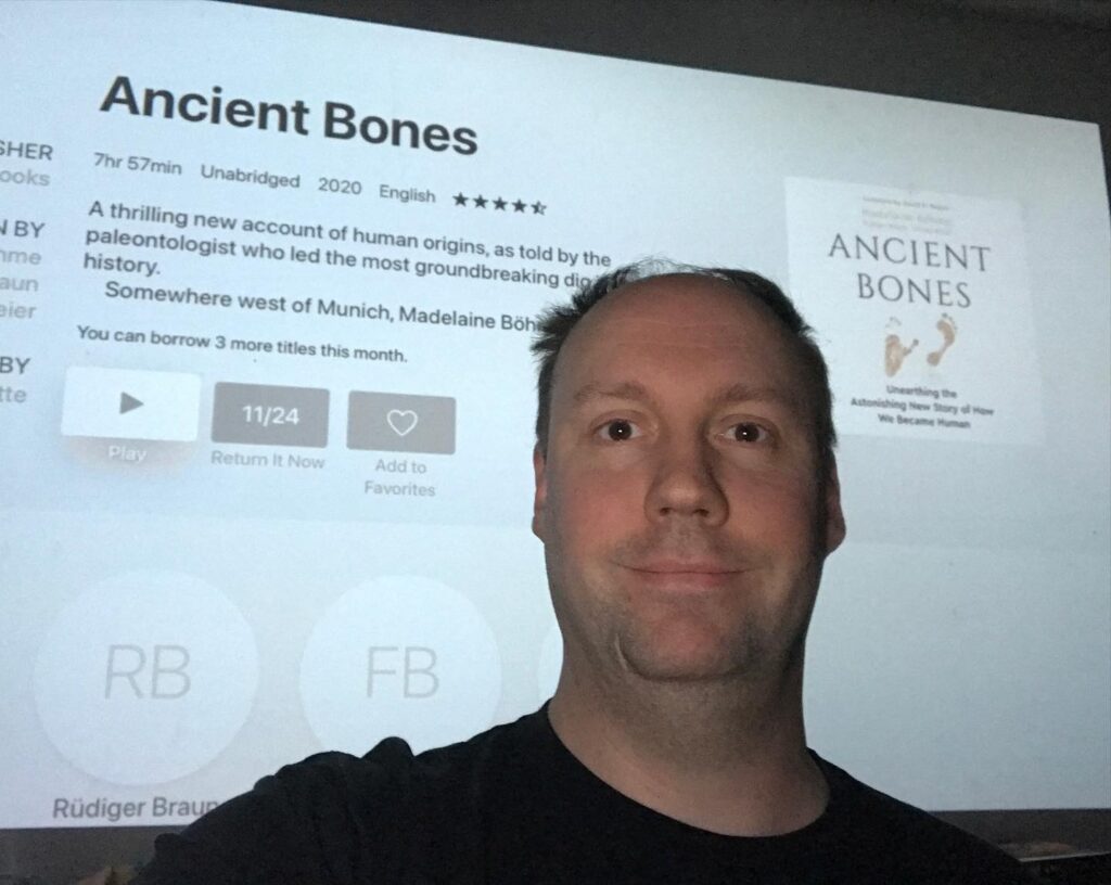 Matt with an audiobook of "Ancient Bones"